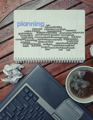 notebook lying on the table with the written words associated wi