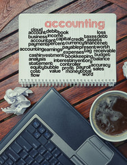 notebook lying on the table with the written words associated wi