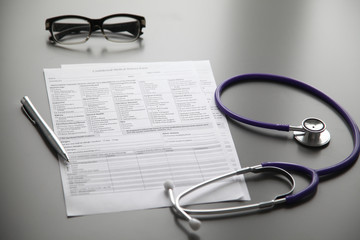 Stethoscope on the grey desk, close up