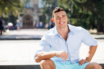 Fototapeta premium Attractive young fit man is resting outdoors