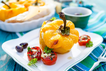 Roasted bell pepper stuffed with quinoa, mushrooms and cheddar cheese with addition aromatic tomatoes