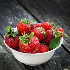 Ripe red strawberries on wooden table