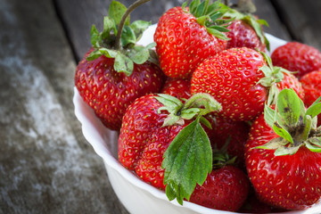 Ripe red strawberries on wooden table