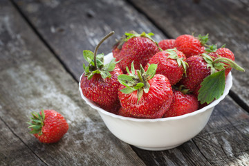 Ripe red strawberries on wooden table