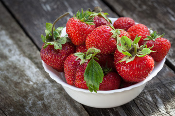Ripe red strawberries on wooden table