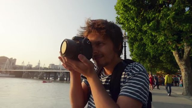 Tourist travel photographer photographing London city at sunset