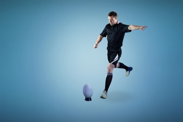 Fototapeta na wymiar Composite image of rugby player doing a drop kick