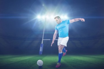 Composite image of rugby player ready to kick