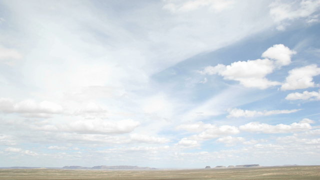 Time lapse shot of white clouds moving over the desert in Shiprock, New Mexico.
