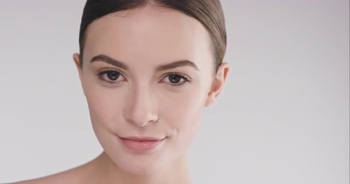 Beauty portrait of woman with beutiful face tilting head up slow motion skincare concept on a grey background slow motion Red Epic Dragon