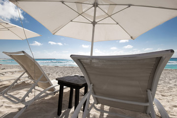 Beach with sun umbrellas and beds