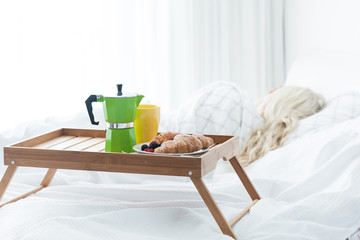 Fototapeta na wymiar Breakfast tray with coffee and croissant