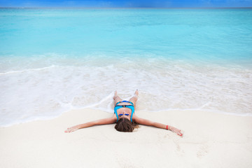 Fototapeta na wymiar Woman on sandy beach enjoying tropical holidays