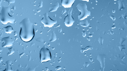 Raindrops on the window. Blue tone