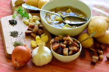 Garlic soup with vintage spoon and ingredients