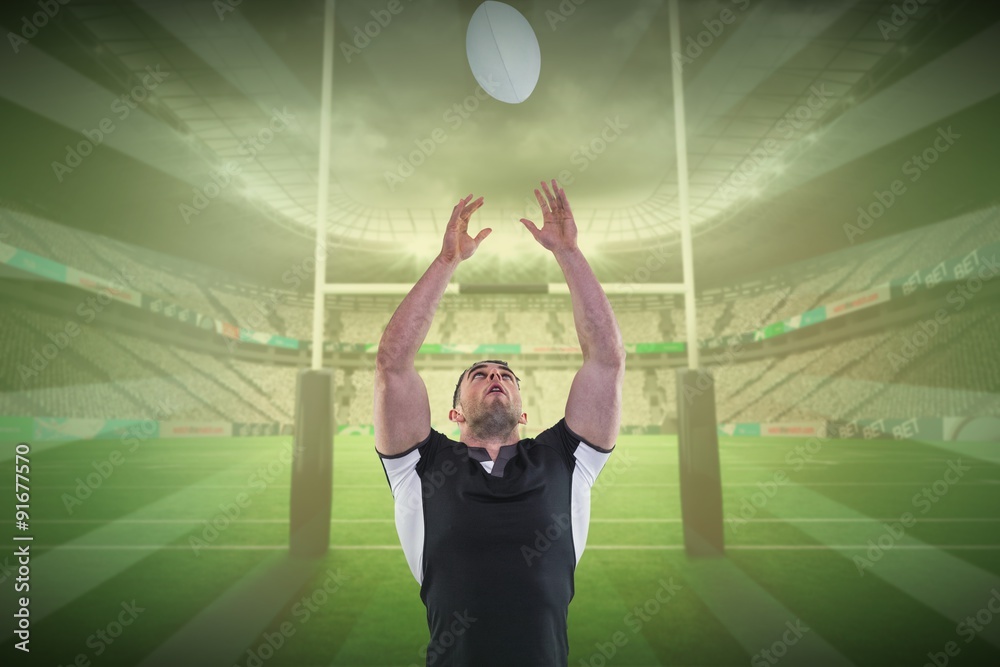 Canvas Prints Composite image of rugby player catching the ball