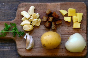 Fototapeta premium Ingredients for garlic soup on chopping board