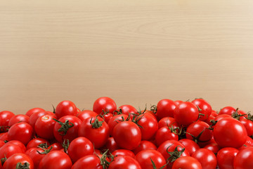 Bunch of ripe tomatoes on a wooden background