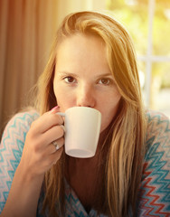 Woman drinking coffee in the morning at restaurant