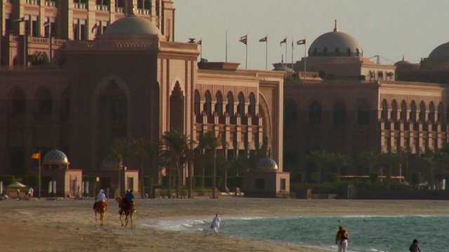 People walk near a mosque in Abu Dhabi, United Arab Emirates.
