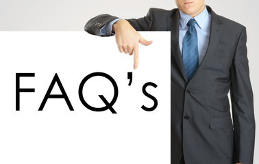 Businessman holding or showing banner with text FAQ's