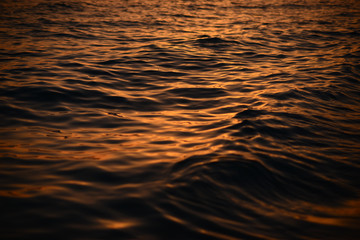 Beautiful golden colors of sunset over sea waves