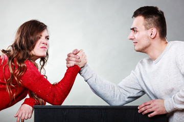 Arm wrestling challenge between young couple