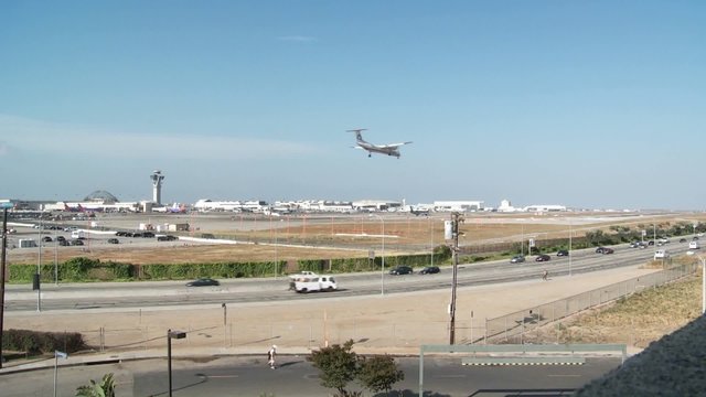 A wide shot of planes take off and taxi at Los Angeles International Airport.