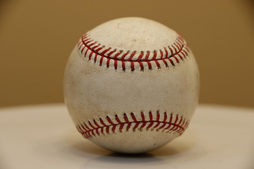 Objects: baseball on a white table
