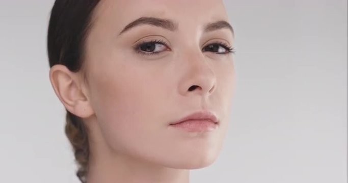 Beauty portrait of woman with beutiful face tilting head up slow motion skincare concept on a grey background slow motion Red Epic Dragon