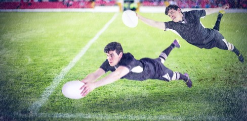 Naklejka premium Composite image of a rugby player scoring a try