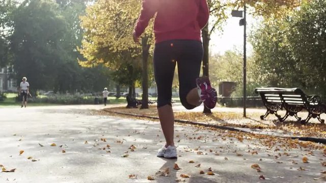 Runner woman running in park exercising outdoors