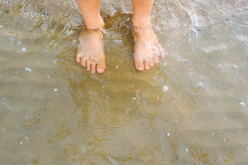 Boy feet in the sea