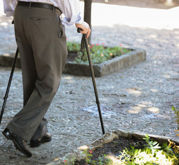 Senior man walking with wooden stick