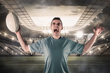 Composite image of a rugby player gesturing victory