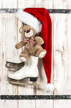 Red Santas hat, Teddy Bear and white ice skates