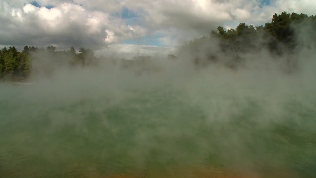 Steam rises off a geothermal lake in New Zealand's Rotorua region.