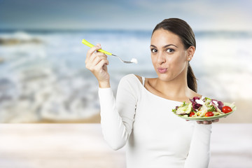 young attractive woman eating salad 