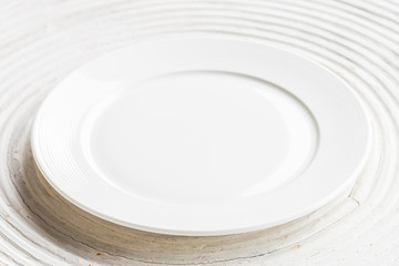 White plate on white wood background