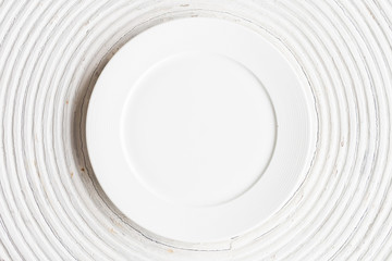 White plate on white wood background