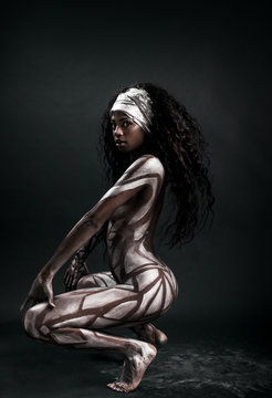 African model body painted with polygons posing