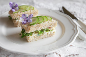 Homemade chicken cucumber cream cheese sandwiches with purple flo