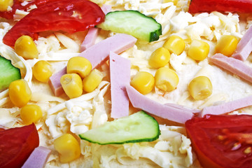 Close-up of homemade pizza with cheese, tomatos, corn, sausage a