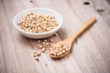 closeup is some soybeans in wooden spoon