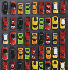 Traffic jam concept with multiple toy cars on a blackboard