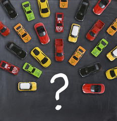 Traffic jam concept with multiple toy cars on a blackboard