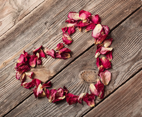 dried rose petals on wooden table