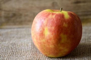 red and yellow apple on jute 