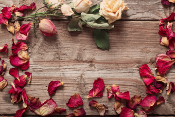 dried rose petals on wooden table