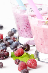 Assorted fruit shakes on white table